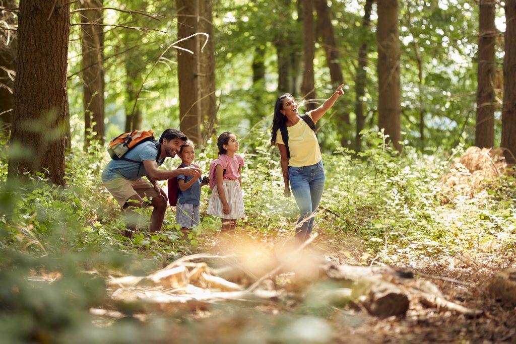 Family enjoying outdoor family activities during a nature scavenger hunt