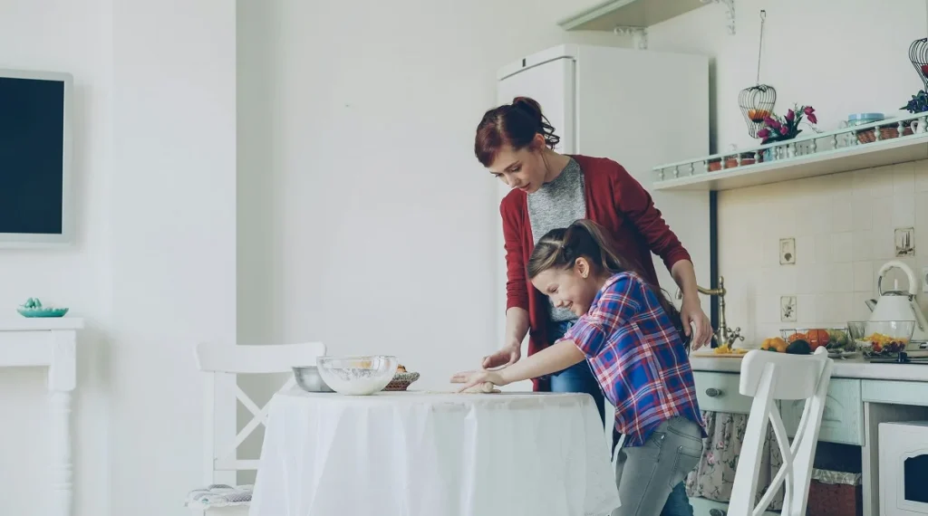 Parent reinforcing family rules by guiding a child through a simple home routine