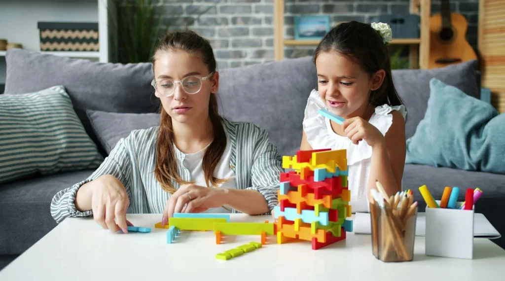 Parent supporting child development while children ask the same questions repeatedly