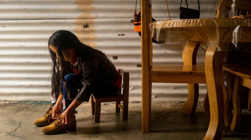 Children build confidence through small daily responsibilities like putting away shoes