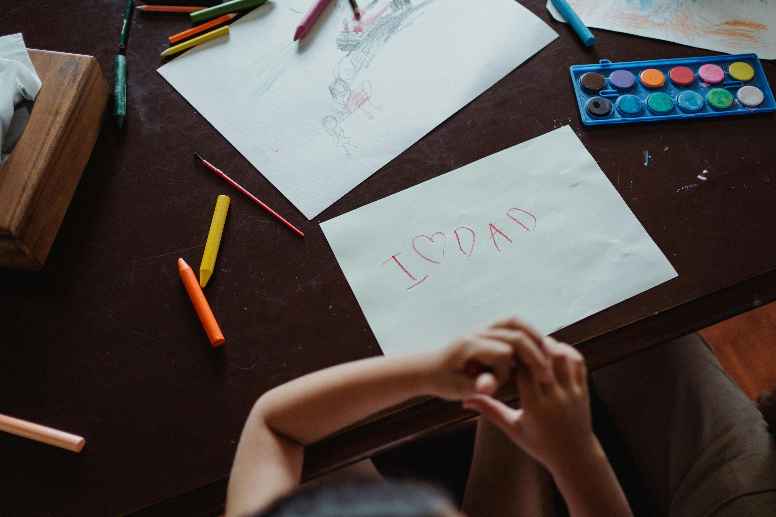 Child transitioning from a screen to a drawing activity at home