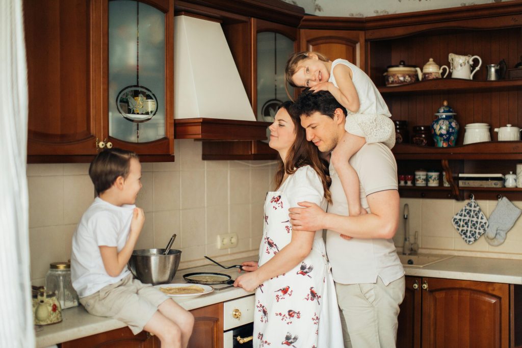 Family cooking together as part of simple weekend family traditions