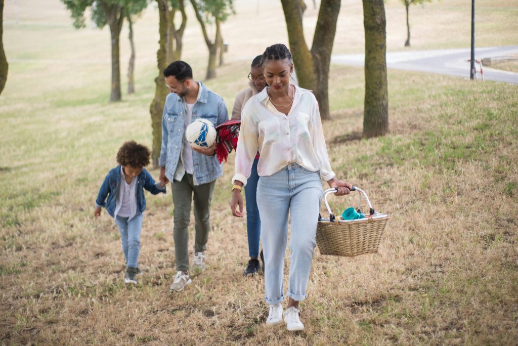 Family enjoying one of their weekend family traditions during a walk outdoors