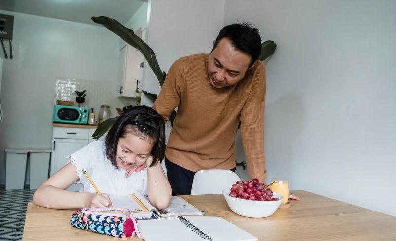 Parent helping a child manage homework resistance at home