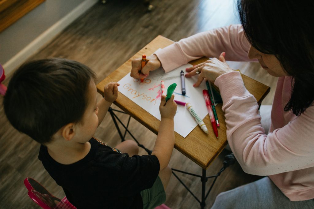 Parent guiding a preschool child through a routine change during the preschool years