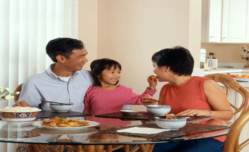 Parent encouraging respectful talk during a family conversation at home