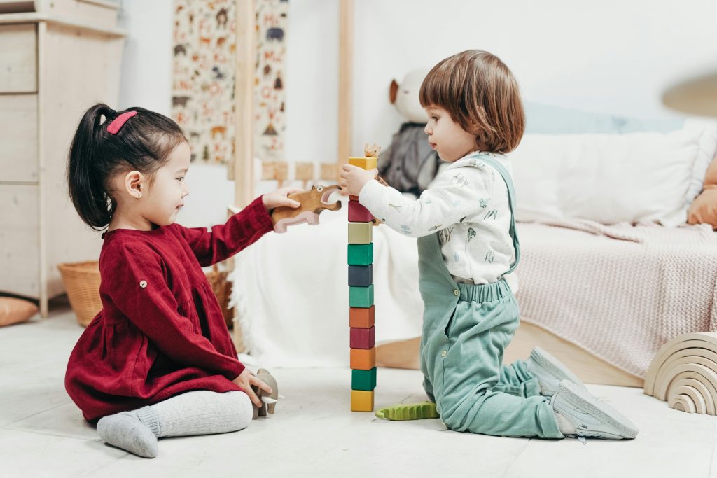 Children building social skills through play by sharing and taking turns