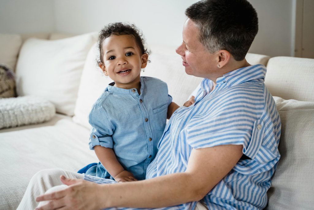 Toddler showing emotional milestones in early childhood by seeking comfort from a parent