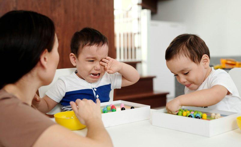 Parent observing emotional milestones in early childhood during quiet play at home