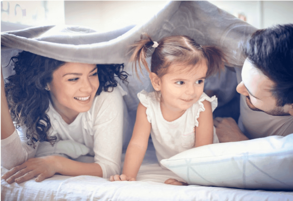 Rainy day family activities with children playing in an indoor blanket fort