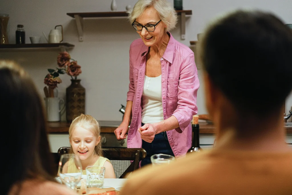 Child learning how not to interrupt conversations during family dinner