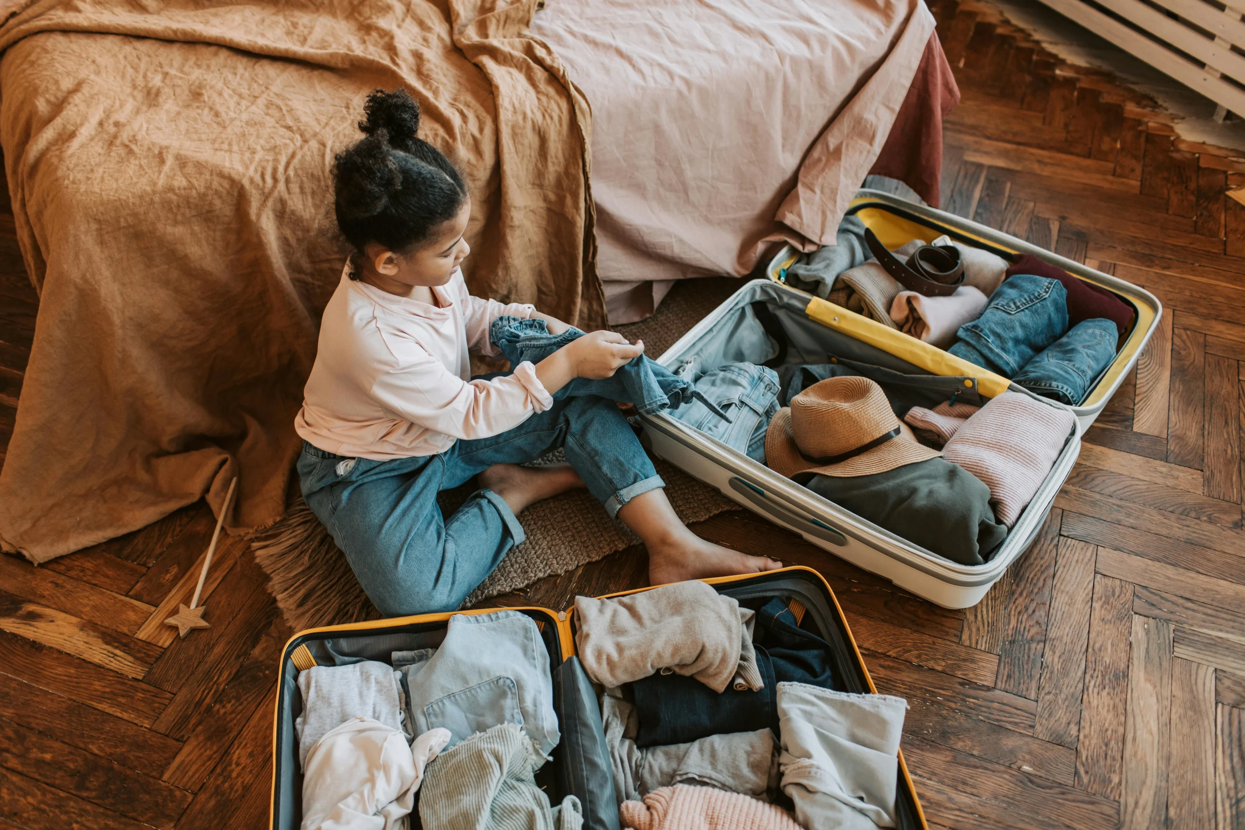 Child packing a backpack as part of a night before routine