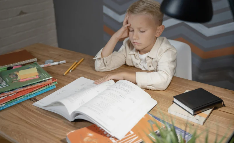 Child showing why children lose focus after school during homework time