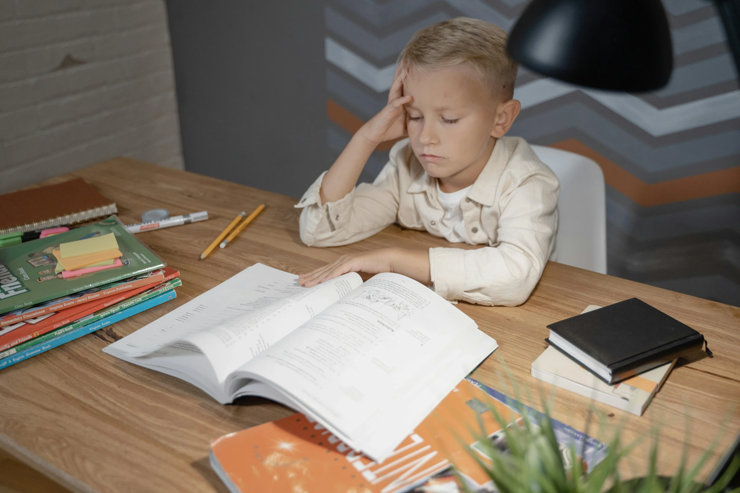Child showing why children lose focus after school during homework time