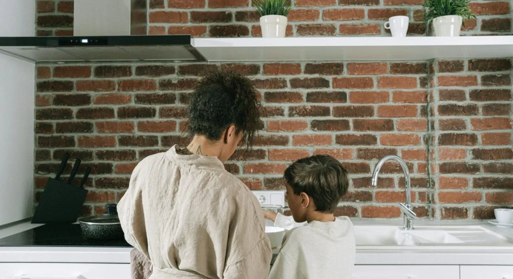 Parent calmly teaching child responsibility after a small routine mistake