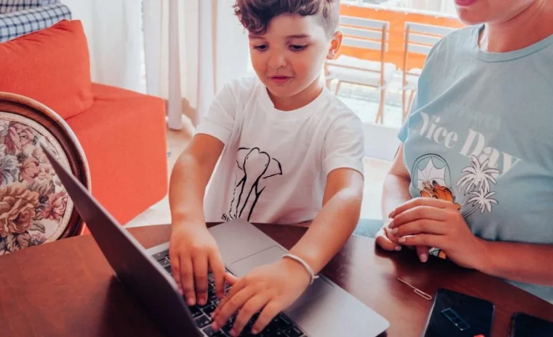 Child keeping a device nearby during another activity at home