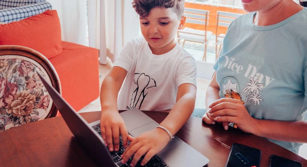 Child keeping a device nearby during another activity at home