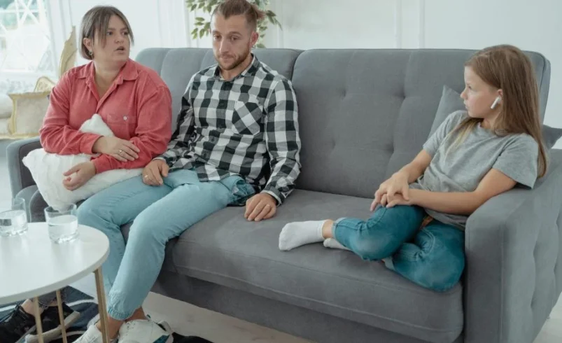 Parent listening closely to a child during a family conversation
