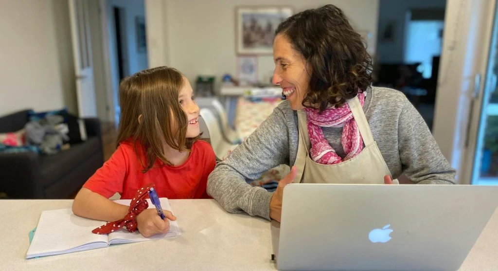 Parent and child using a checklist to stop children forgetting school items