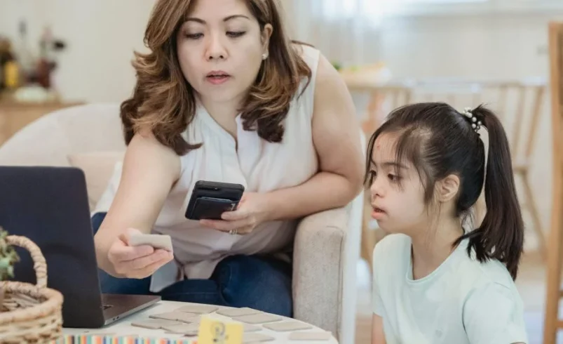 Parent giving focused support to one child during a calm home moment