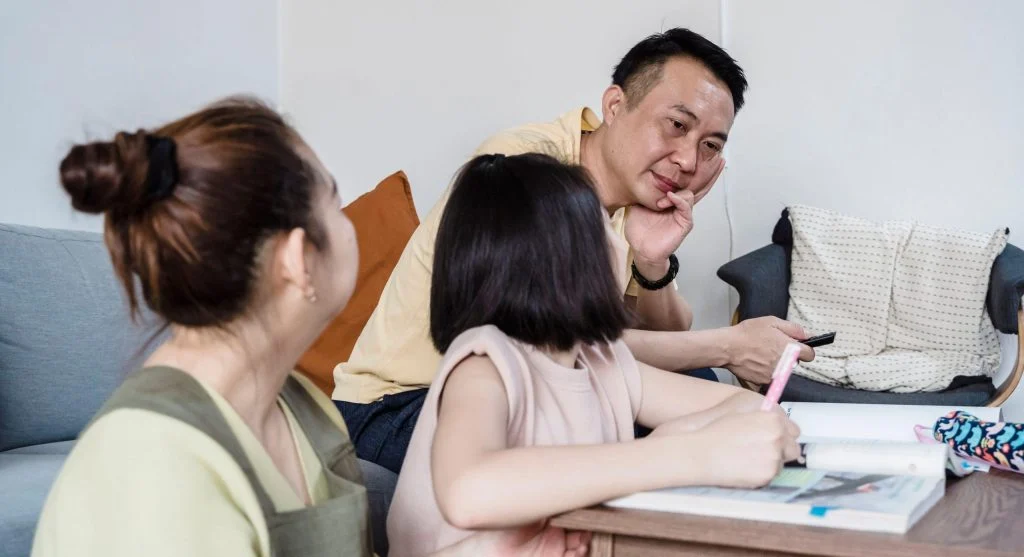 Parent talking calmly with children during a family support moment