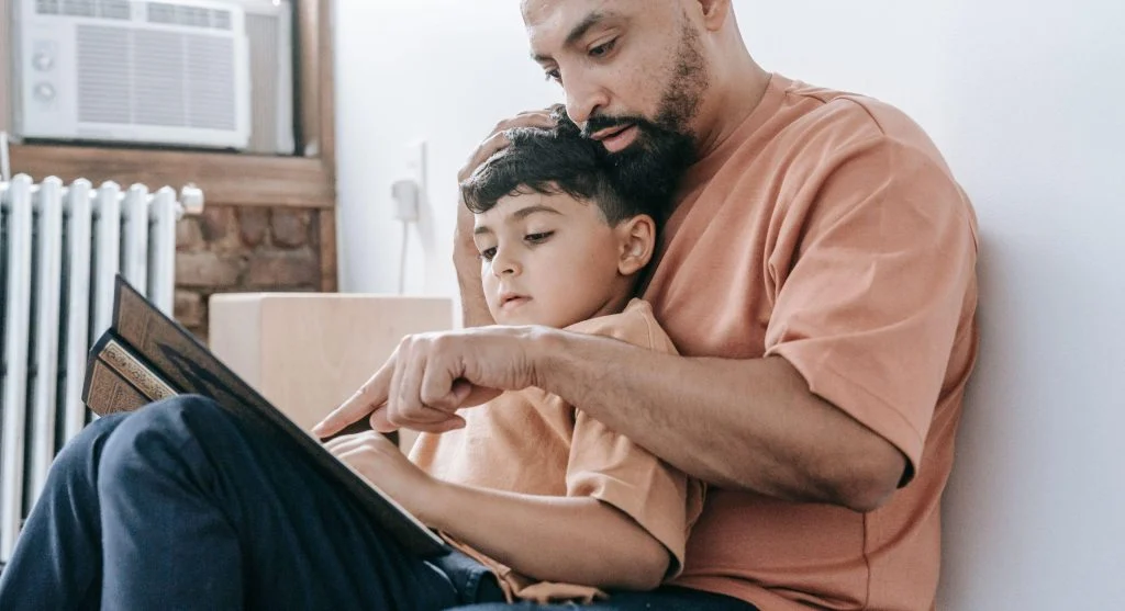 Parent and child reviewing the week at a shared family calendar spot