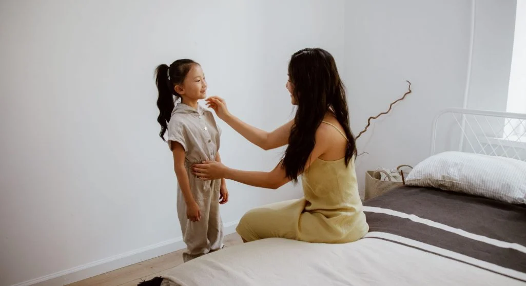 Parent offering partial support while a child practices independence