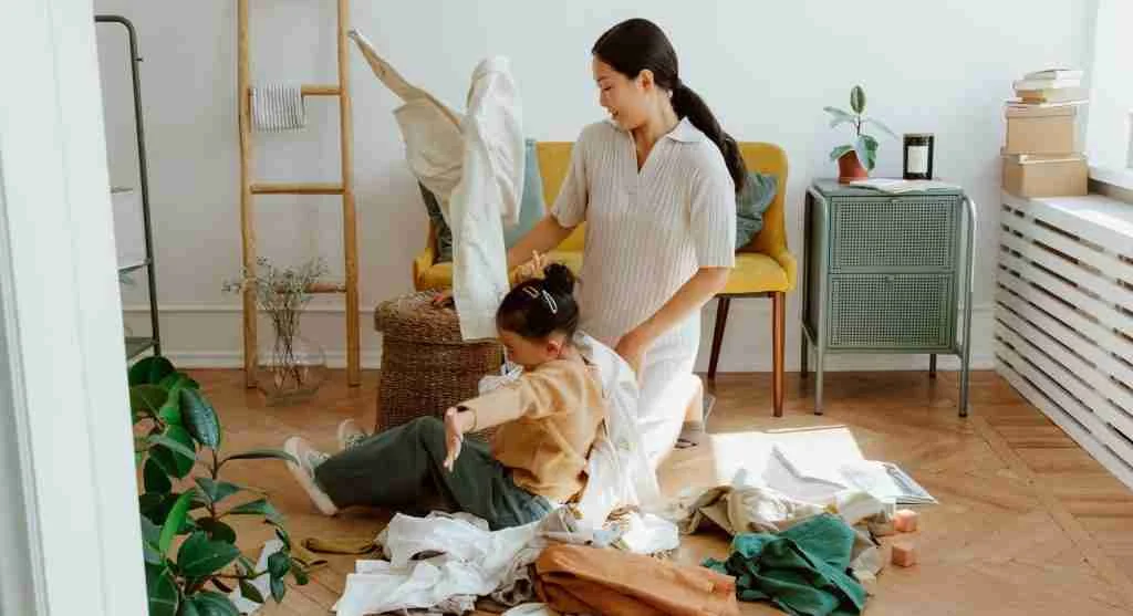 Parent and child reviewing clothes before returning them to active rotation