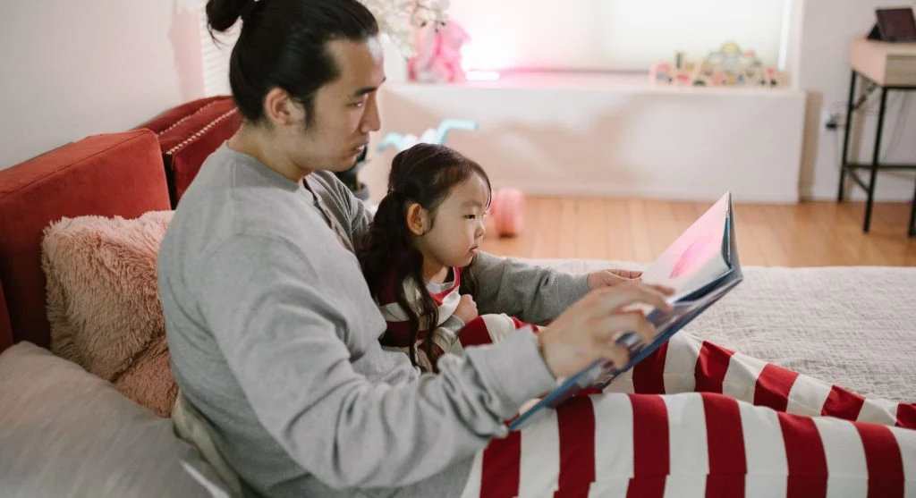 Child settling into a calm evening reading routine during family wind-down time