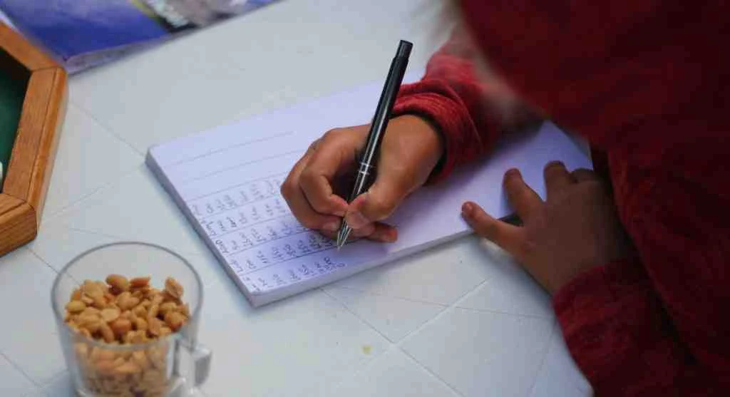 Child revising work after making a mistake during a learning activity