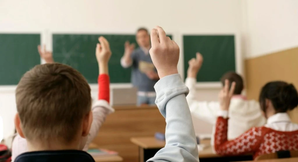 Child pausing in class before speaking an answer aloud