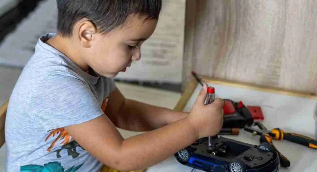 Child testing a toy after completing a simple family repair