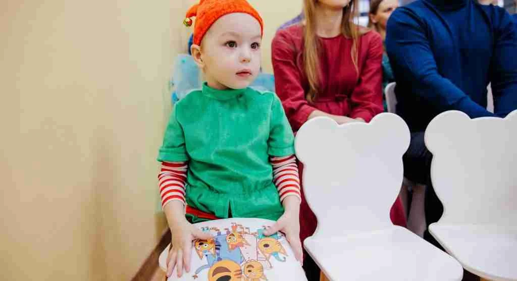 Child practicing waiting before correcting someone during a family conversation