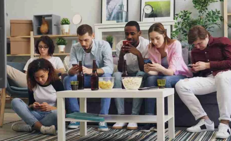 Child feeling left out while friends discuss online content on a device
