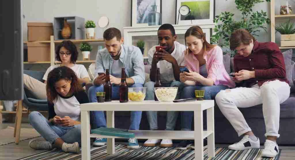 Child feeling left out while friends discuss online content on a device