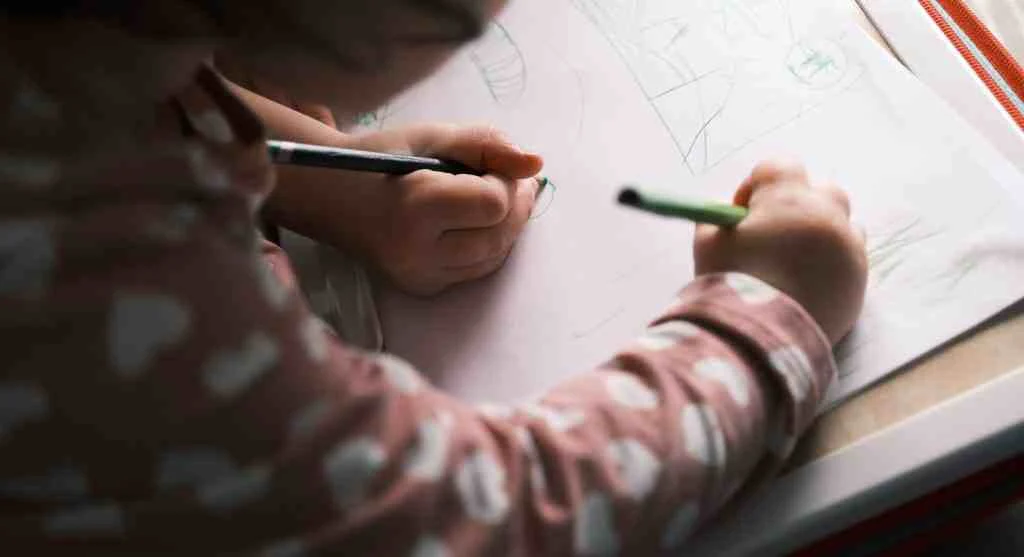 Child creating an imaginative map with routes and landmarks