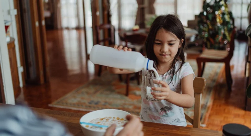 Child practicing independence within a structured family routine