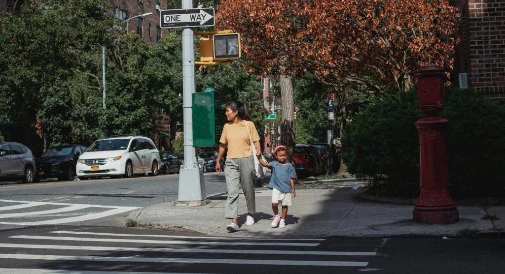 Family taking a short neighborhood walk as part of an ordinary evening routine