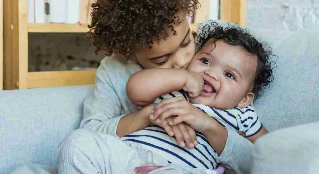 Younger child offering support to an older sibling