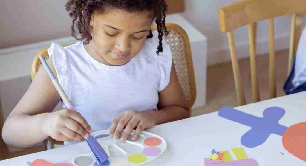 Child exploring a familiar drawing through different art materials