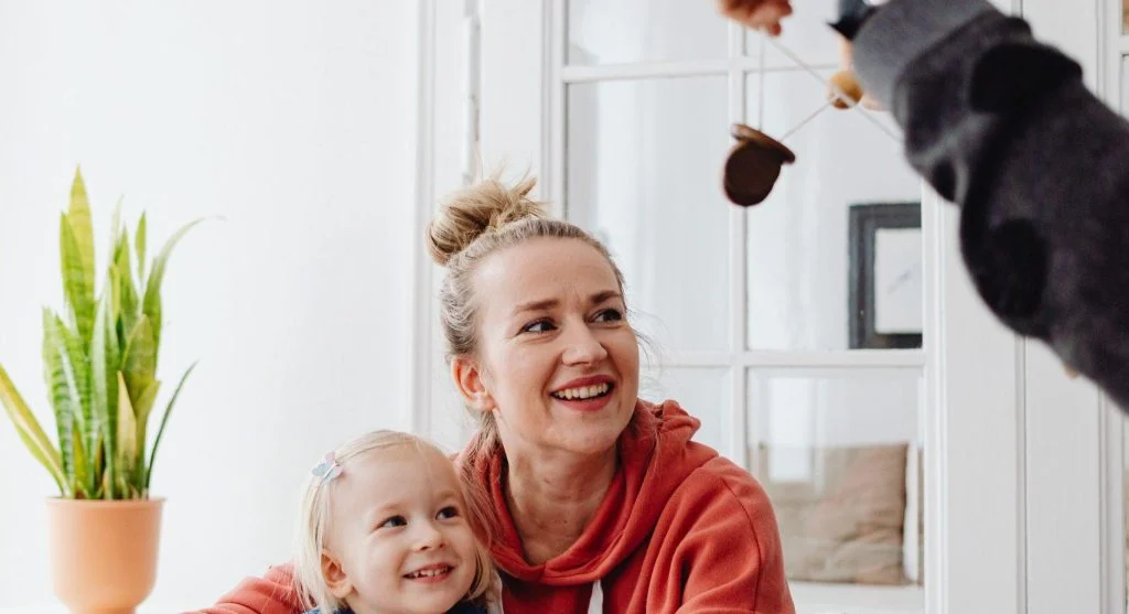 Parent and child organizing a collection of tiny objects together