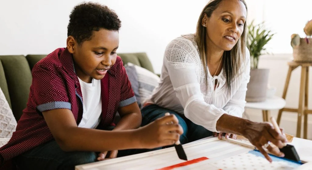Parent helping a child process a social inclusion experience after school