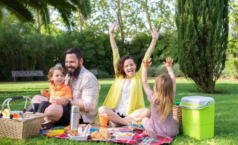 Family enjoying an outdoor outing with children who have different energy levels