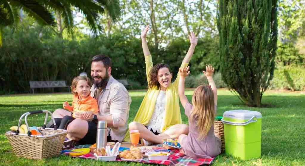 Family enjoying an outdoor outing with children who have different energy levels
