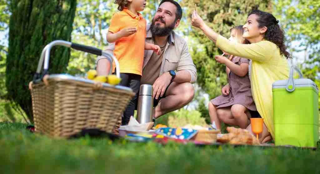 Family taking a snack and water break during a day out