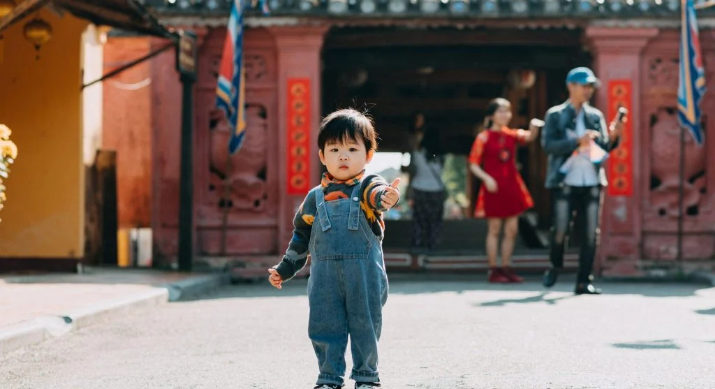 Curious child in public while parent responds calmly to an unexpected question