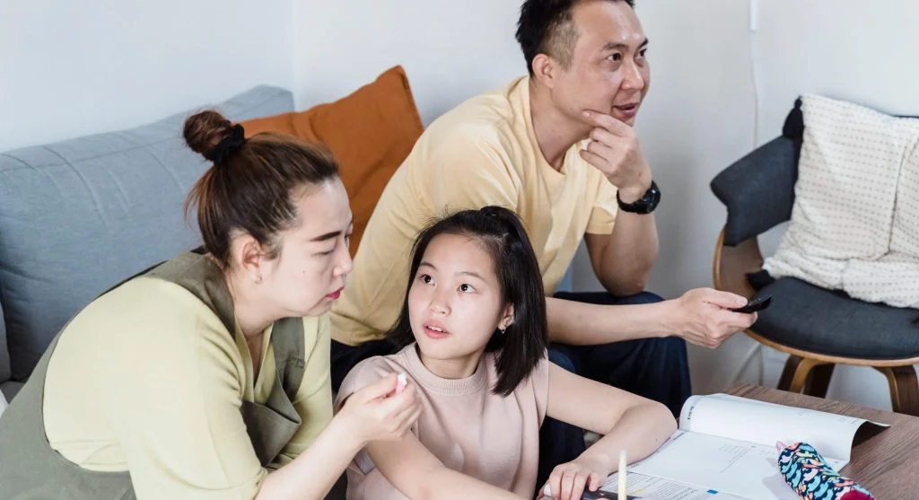 Parent listening carefully while a child explains a different version of what happened