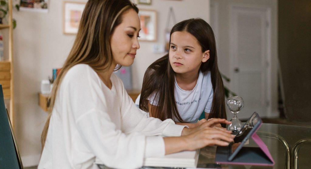 Parent calmly reviewing a changed family plan with a tween