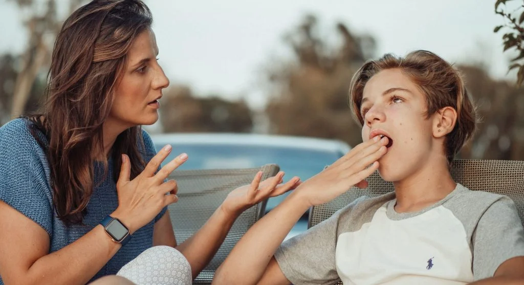 Parent calmly explaining a family rule while child listens carefully