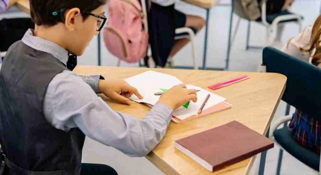 Child creating easy-to-read note cards for a class presentation